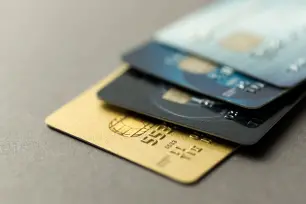 A pile of credit cards on a desk