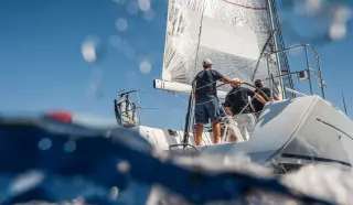 Friends enjoying sailboat that was purchased on a boat loan from People's Community Federal Credit Union