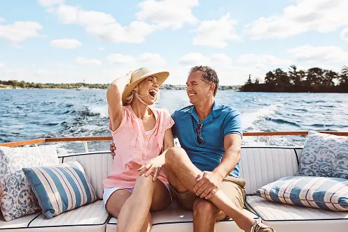 Happy couple riding together in a boat financed by People's Community Federal Credit Union