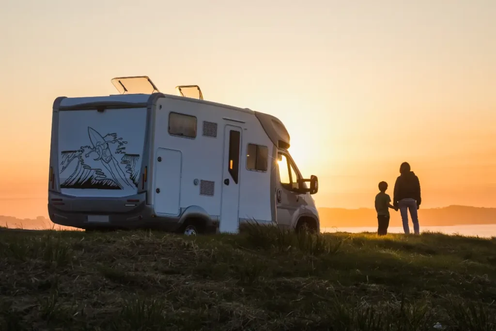 Mother and son enjoy breathtaking Pacific Northwest view next to camper financed with RV loan through People’s Community Federal Credit Union
