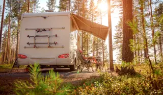 Sitting under the awning on an RV. Contact People's Community Federal Credit Union to get a recreational vehicle loan that suits your lifestyle.