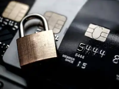A brass padlock resting on credit cards to illustrate payment security and financial protection.